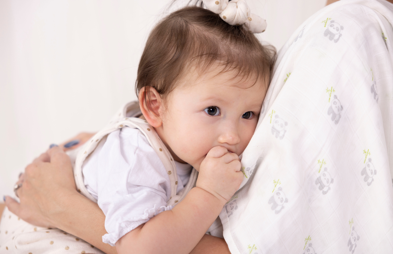 Little girl hugging mum When Should I Stop Swaddling my baby?